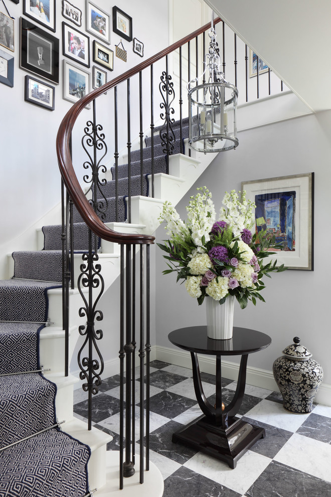 Mid-sized traditional painted wood curved staircase in London with painted wood risers.
