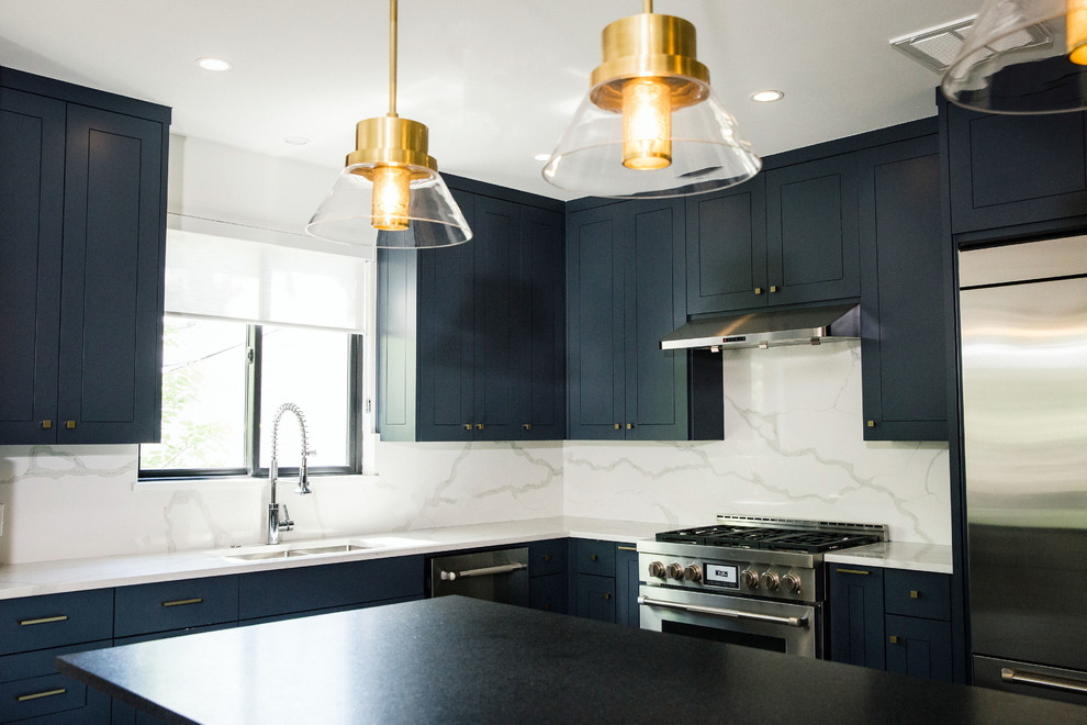Example of a mid-sized transitional l-shaped cement tile floor and gray floor eat-in kitchen design in Austin with an undermount sink, flat-panel cabinets, blue cabinets, quartz countertops, white backsplash, stainless steel appliances, an island and white countertops