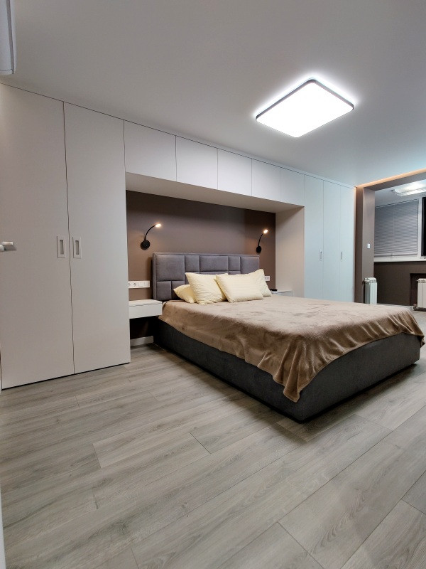Inspiration for a mid-sized contemporary master laminate floor, gray floor and wallpaper bedroom remodel in Moscow with brown walls and no fireplace