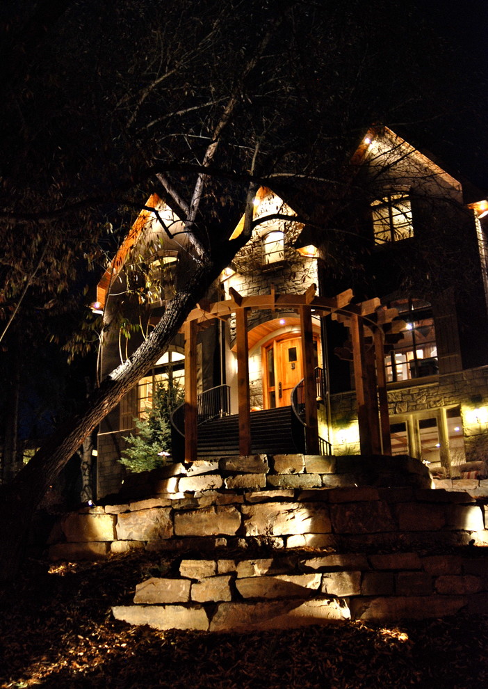 Inspiration for a mid-sized rustic front yard stone retaining wall landscape in Calgary.