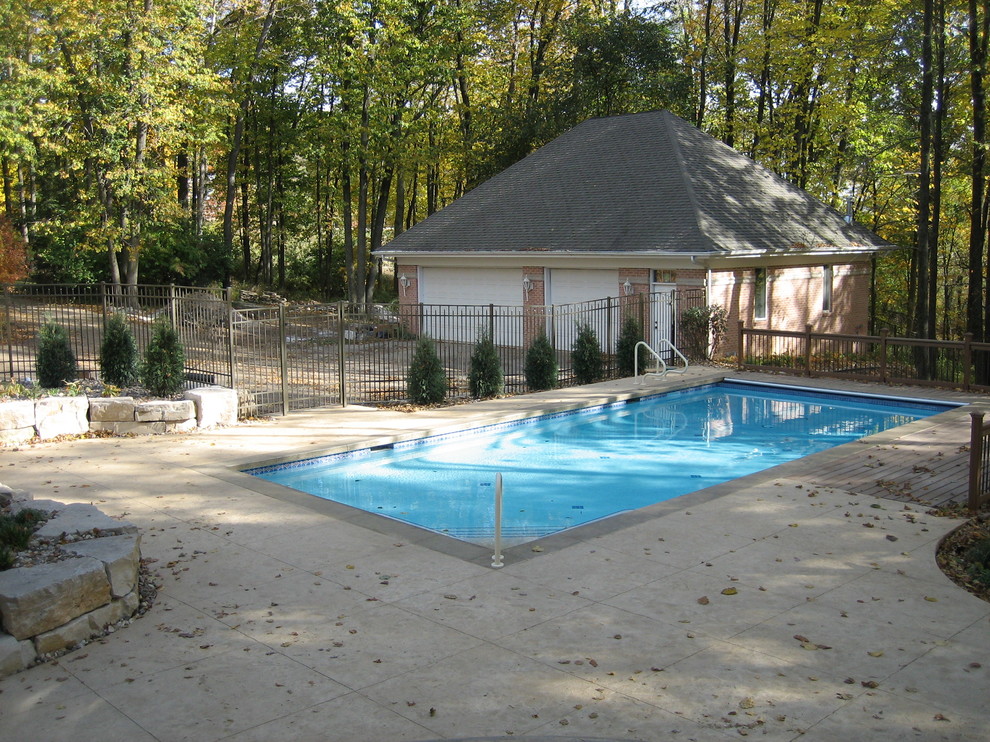 Pool house - large transitional backyard concrete paver and rectangular natural pool house idea in Cedar Rapids