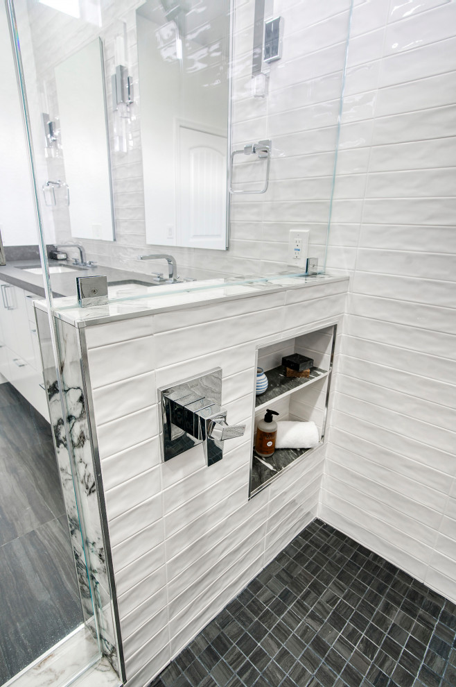 Large contemporary ensuite bathroom in Phoenix with flat-panel cabinets, white cabinets, a double shower, a bidet, black and white tiles, porcelain tiles, white walls, porcelain flooring, a submerged sink, granite worktops, black floors, a hinged door, black worktops, a wall niche, double sinks and a built in vanity unit.