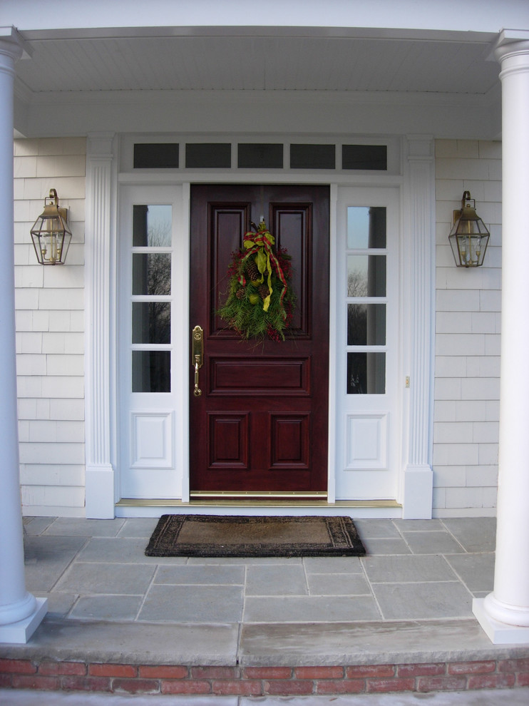 Photo of a mid-sized traditional front door in New York with a single front door and a dark wood front door.