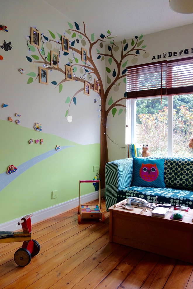 Inspiration for a small eclectic gender-neutral kids' room in Other with multi-coloured walls and medium hardwood floors.