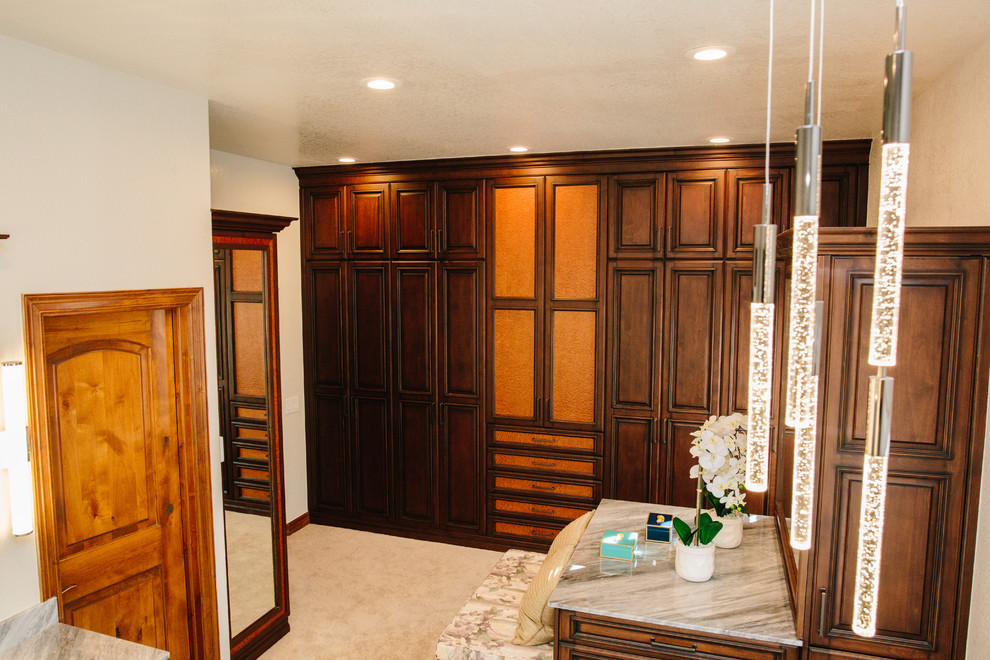 Design ideas for an expansive traditional wardrobe in Denver with raised-panel cabinets, medium wood cabinets, marble flooring and white floors.