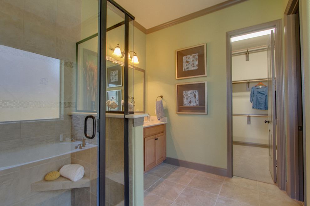 Inspiration for a traditional master bathroom in Houston with shaker cabinets, light wood cabinets, a curbless shower, beige tile, ceramic tile, green walls, ceramic floors, beige floor, a hinged shower door and white benchtops.