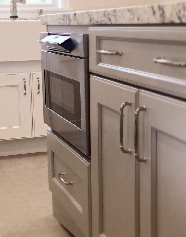 Inspiration for a mid-sized transitional u-shaped ceramic tile eat-in kitchen remodel in Houston with a farmhouse sink, recessed-panel cabinets, white cabinets, granite countertops, white backsplash, stone tile backsplash, stainless steel appliances and an island
