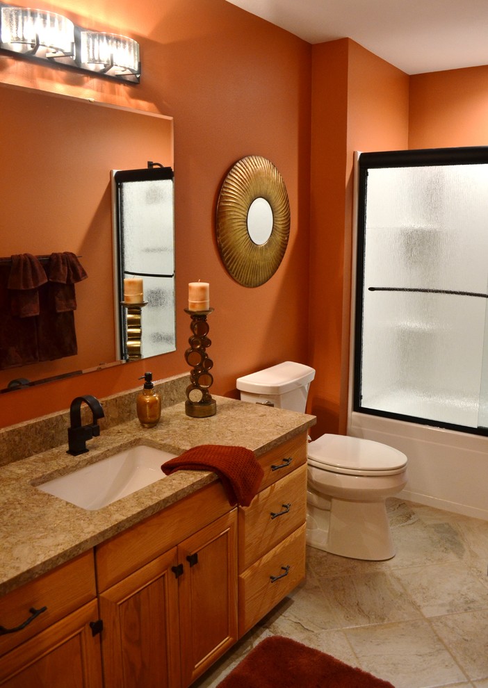 This is an example of a mid-sized eclectic 3/4 bathroom in Other with medium wood cabinets, a corner shower, beige tile, porcelain tile, orange walls, porcelain floors, an undermount sink and engineered quartz benchtops.