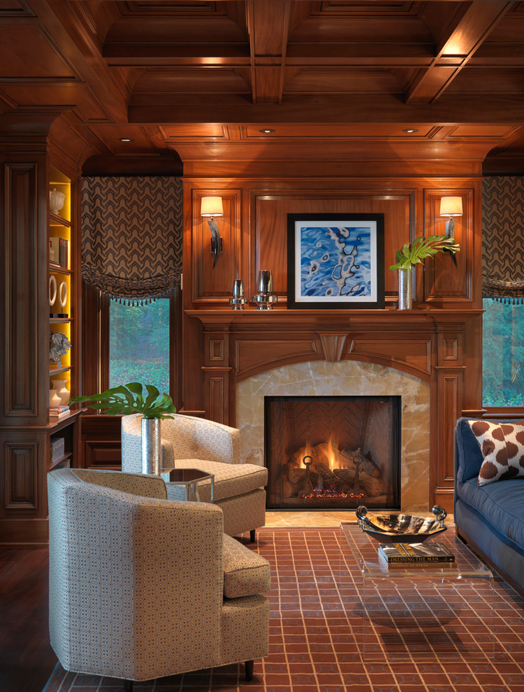This is an example of a traditional family room in Boston with a wood fireplace surround.