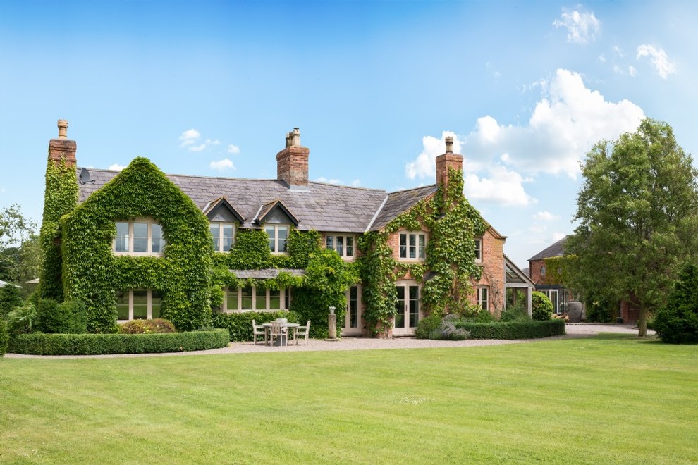 Inspiration for an expansive country two-storey brick house exterior in Cheshire with a hip roof.