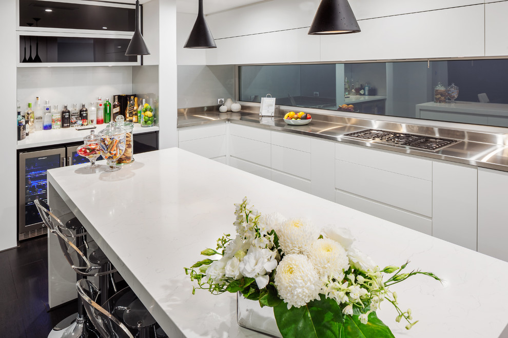 Photo of a modern kitchen in Perth with flat-panel cabinets, white cabinets, quartz benchtops, with island, white benchtop and window splashback.