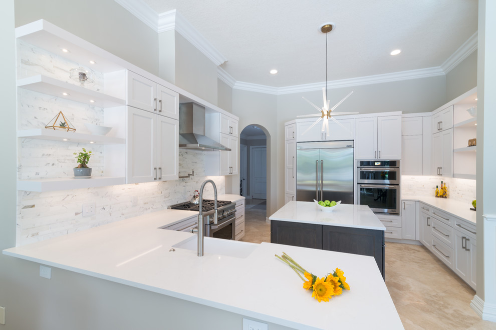 Mid-sized transitional u-shaped separate kitchen in Miami with a farmhouse sink, shaker cabinets, white cabinets, white splashback, stone tile splashback, stainless steel appliances, with island, quartz benchtops, porcelain floors and beige floor.