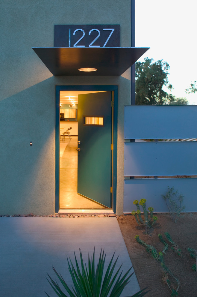 Contemporary entryway in Phoenix with a single front door and concrete floors.