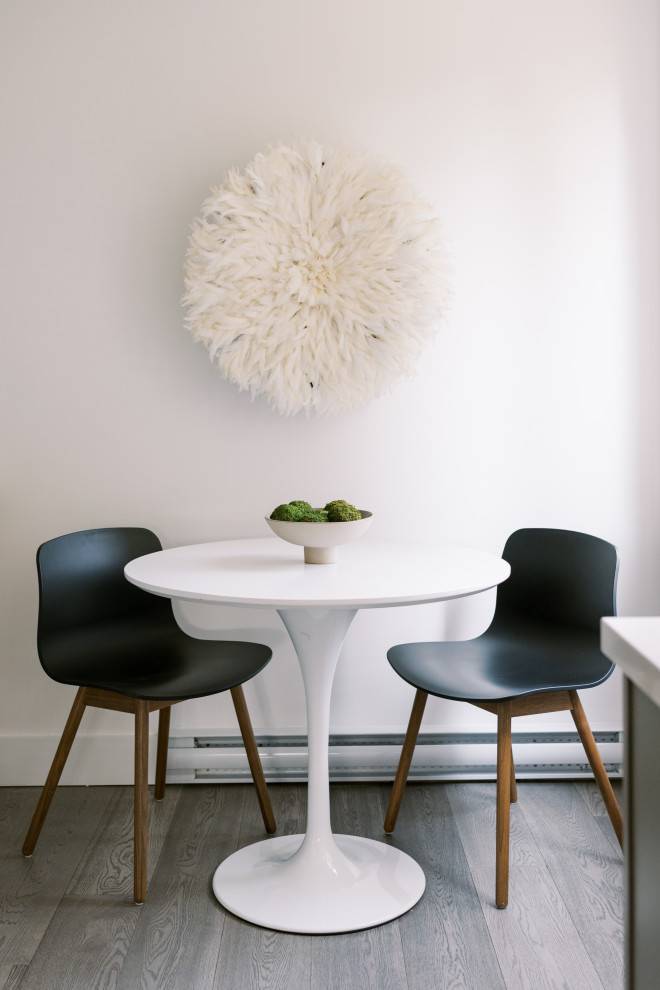 Aménagement d'une petite salle à manger contemporaine avec une banquette d'angle, un mur beige, un sol en bois brun et un sol gris.