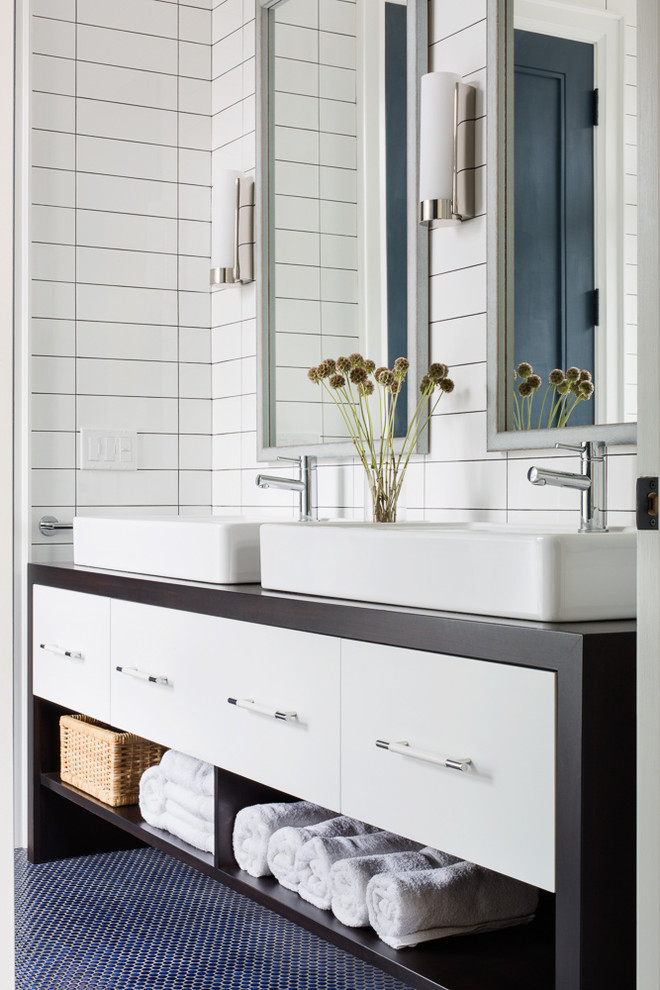 Photo of a mid-sized contemporary bathroom in Toronto with flat-panel cabinets, white cabinets, wood benchtops, a corner shower, a one-piece toilet, white tile, ceramic tile, white walls, mosaic tile floors, a vessel sink and brown benchtops.