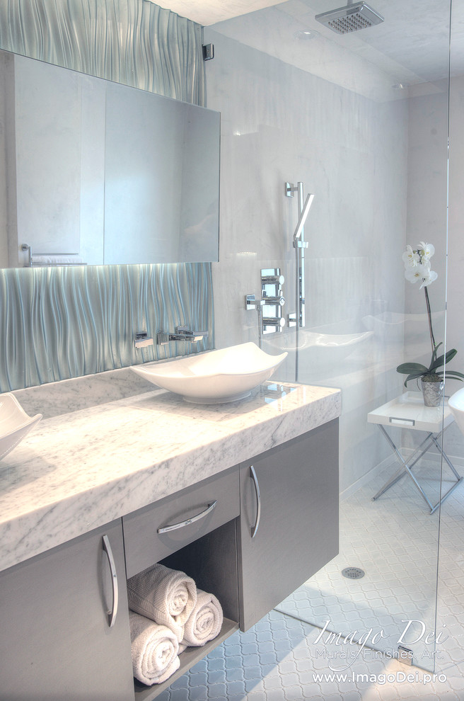 Inspiration for a small transitional master bathroom in Houston with a vessel sink, flat-panel cabinets, grey cabinets, marble benchtops, a freestanding tub, a shower/bathtub combo, a two-piece toilet, blue tile, ceramic tile, white walls and ceramic floors.