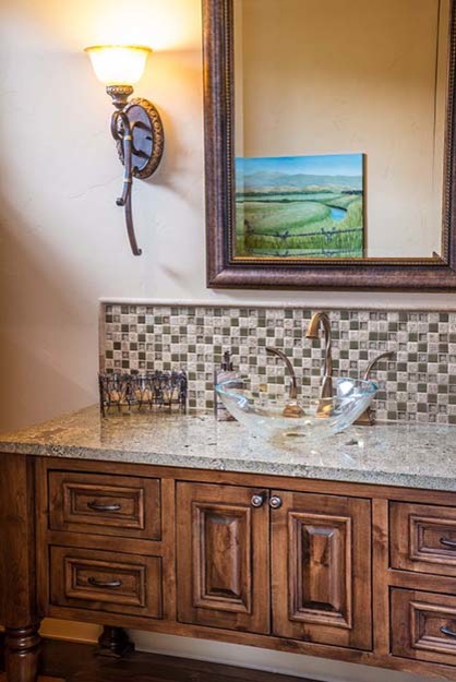 Example of a mid-sized gray tile and glass tile medium tone wood floor powder room design with beaded inset cabinets, medium tone wood cabinets, beige walls, a vessel sink and granite countertops