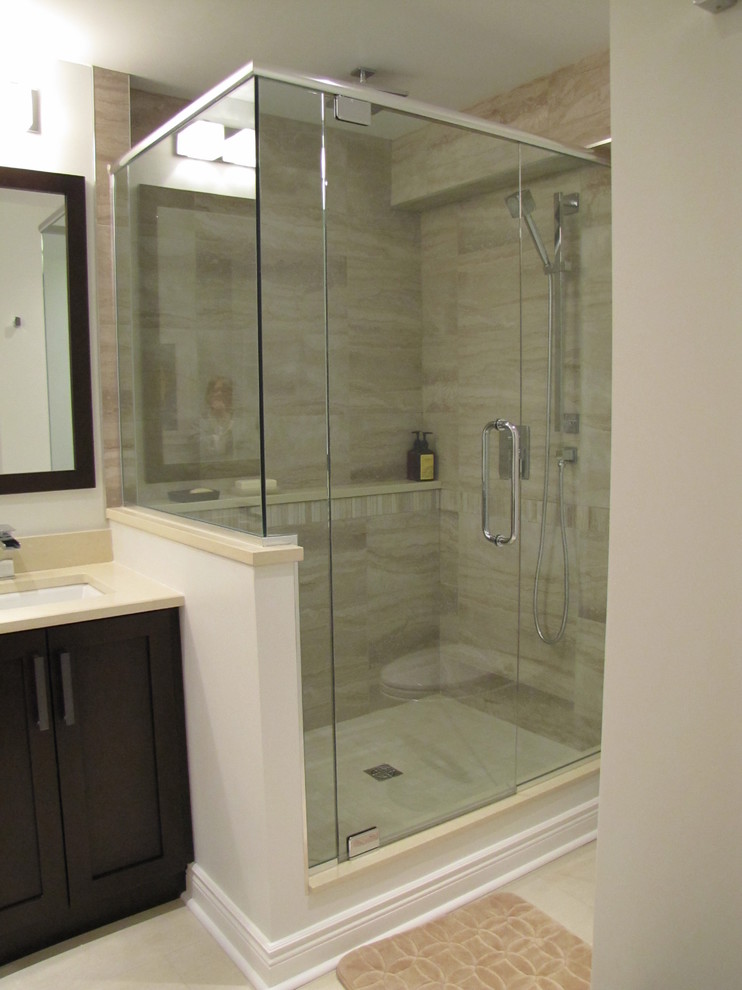 This is an example of a small transitional master bathroom in Ottawa with shaker cabinets, dark wood cabinets and beige tile.