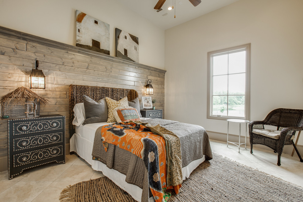 Mid-sized mediterranean guest bedroom in Dallas with beige walls, porcelain floors, a standard fireplace and a stone fireplace surround.