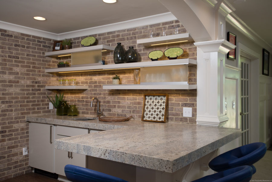 Photo of a large transitional l-shaped seated home bar in Atlanta with flat-panel cabinets, white cabinets, granite benchtops, beige splashback and carpet.