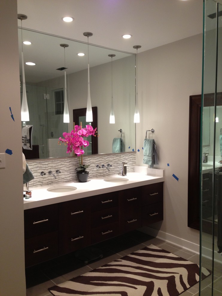 Inspiration for a mid-sized asian master bathroom in Richmond with flat-panel cabinets, dark wood cabinets, gray tile, glass tile, beige walls, ceramic floors, an undermount sink, laminate benchtops, grey floor and a hinged shower door.