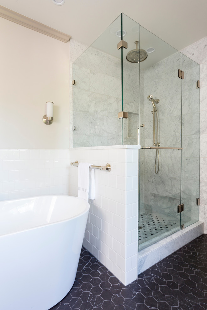 Design ideas for a large transitional master wet room bathroom in Portland with shaker cabinets, white cabinets, a freestanding tub, a one-piece toilet, white tile, ceramic tile, beige walls, ceramic floors, an undermount sink, marble benchtops, brown floor, a hinged shower door and multi-coloured benchtops.