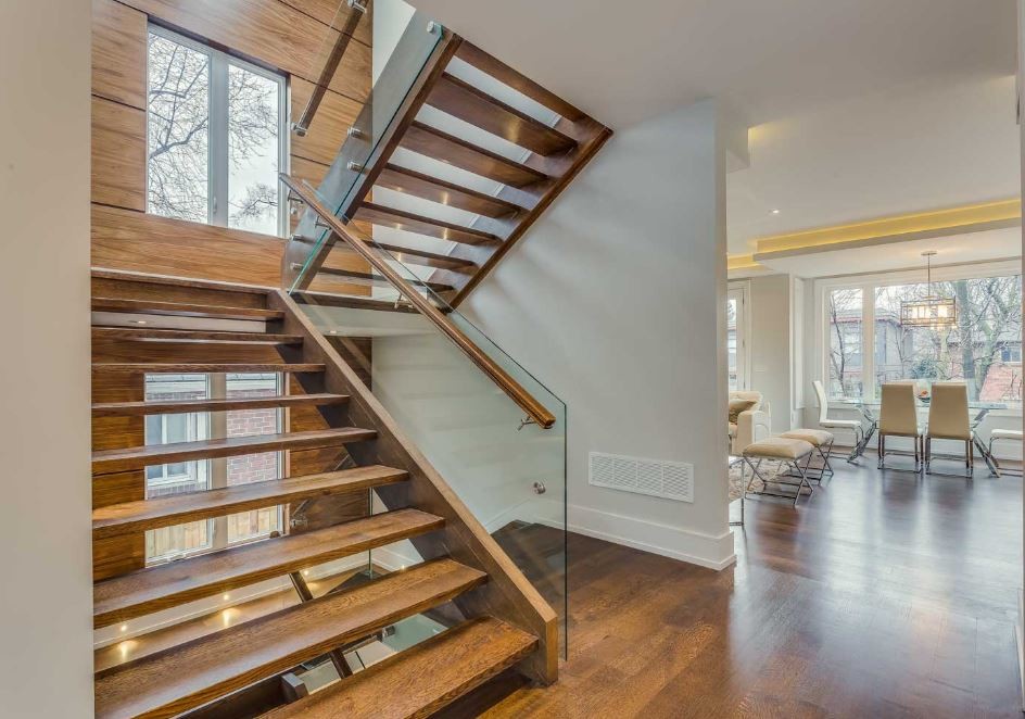 Mid-sized modern wood floating staircase in Toronto with open risers.