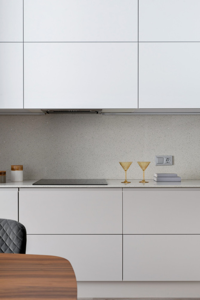 Inspiration for a mid-sized contemporary l-shaped eat-in kitchen in Other with an undermount sink, flat-panel cabinets, grey cabinets, quartz benchtops, grey splashback, engineered quartz splashback, black appliances, vinyl floors, no island, brown floor and grey benchtop.