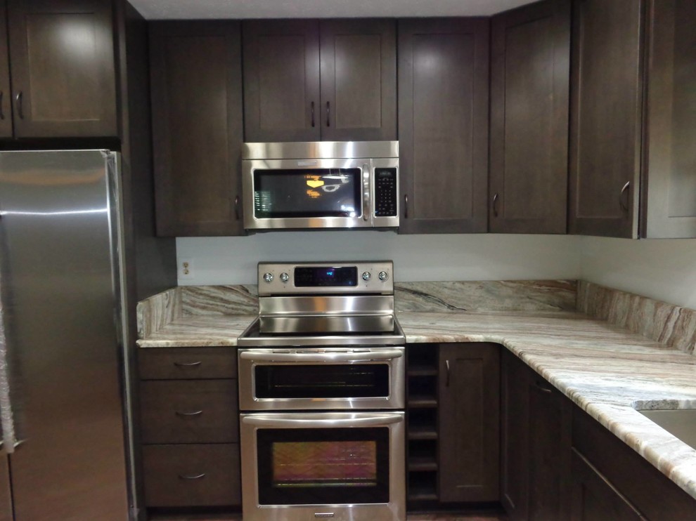 Inspiration for a small transitional u-shaped brick floor and red floor eat-in kitchen remodel in Baltimore with an undermount sink, shaker cabinets, granite countertops, brown backsplash, stone tile backsplash, stainless steel appliances, a peninsula and brown cabinets