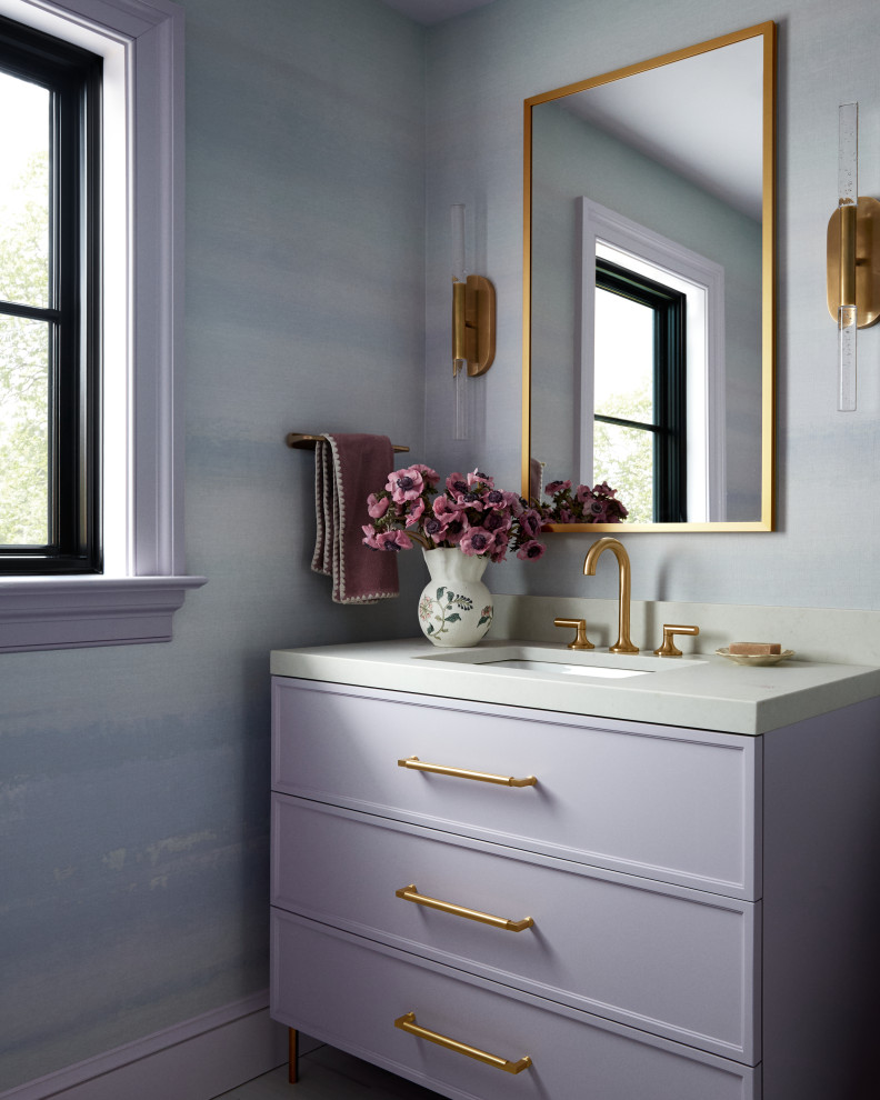 Cheswold - Inspiration for a transitional wallpaper powder room remodel with shaker cabinets, purple cabinets, blue walls, an undermount sink, gray countertops and a freestanding vanity