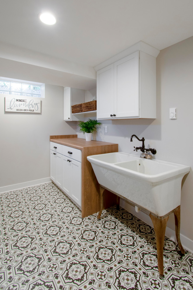 Inspiration for a large transitional underground vinyl floor basement remodel in Milwaukee with gray walls