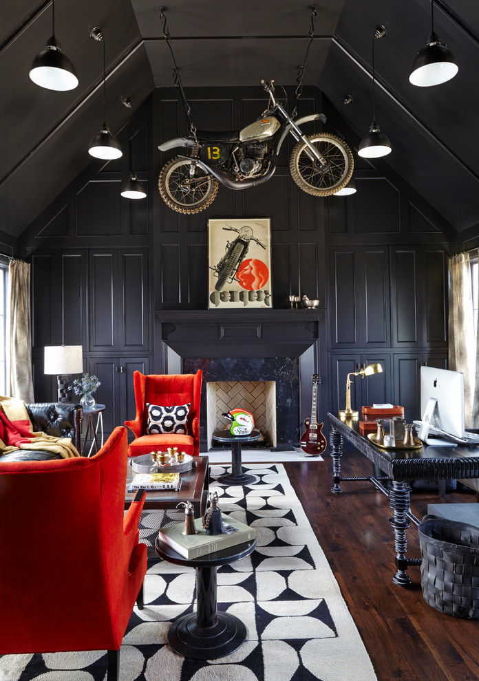 Eclectic freestanding desk dark wood floor study room photo in Nashville with black walls, a standard fireplace and a stone fireplace