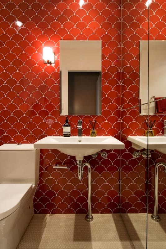 Photo of a small modern powder room in Sydney with a wall-mount sink, a one-piece toilet, red tile, ceramic tile, red walls and ceramic floors.