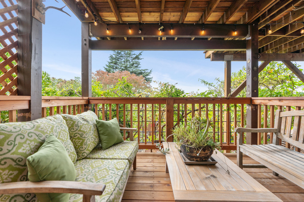 Example of a large mountain style backyard second story wood railing deck design in San Francisco with no cover