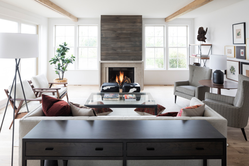 Inspiration for a country open concept living room in Minneapolis with white walls, medium hardwood floors, a standard fireplace and brown floor.