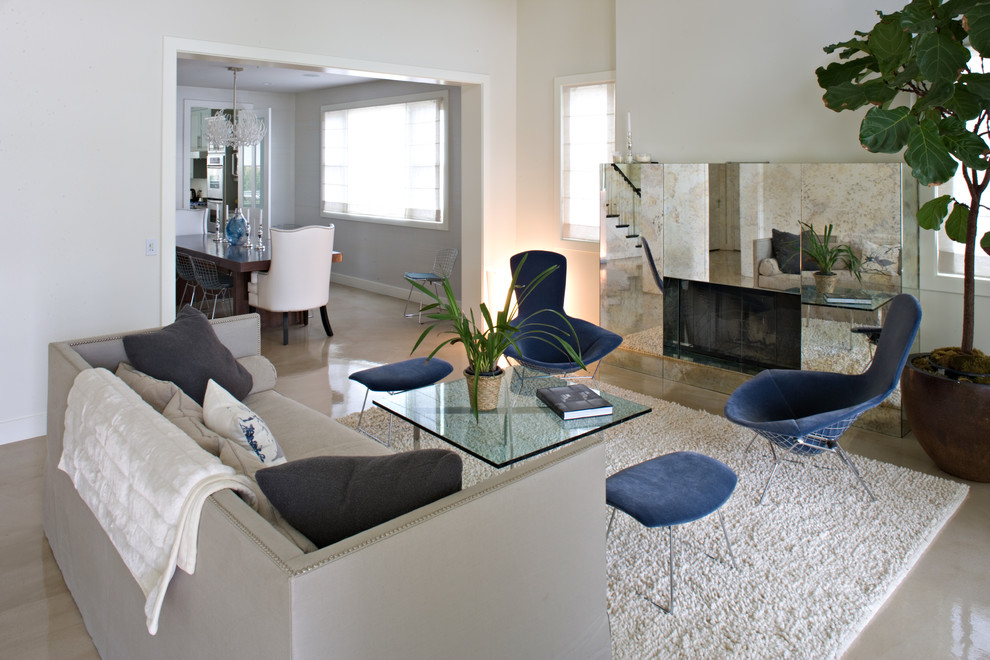 This is an example of a contemporary living room in Los Angeles with white walls and a standard fireplace.