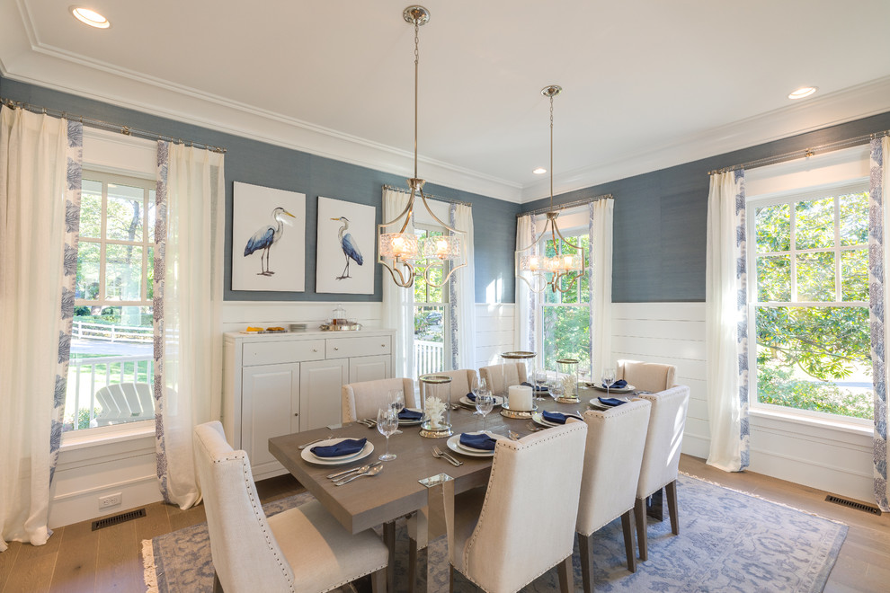Large beach style open plan dining in Other with blue walls, medium hardwood floors and grey floor.