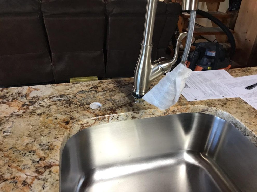 Mid-sized mountain style l-shaped light wood floor and beige floor eat-in kitchen photo with an undermount sink, recessed-panel cabinets, light wood cabinets, granite countertops, stainless steel appliances, no island and beige countertops