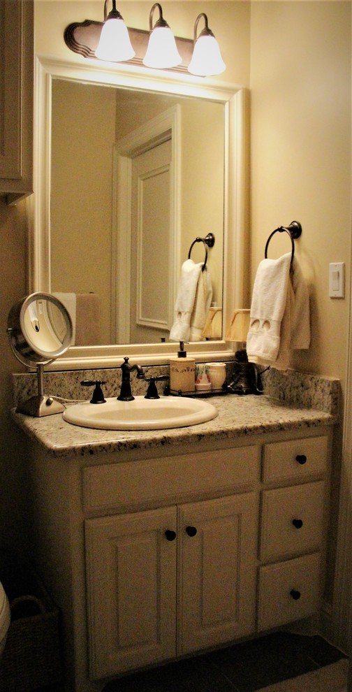 Photo of a small traditional 3/4 bathroom in Dallas with raised-panel cabinets, white cabinets, a curbless shower, a one-piece toilet, beige walls, a drop-in sink, tile benchtops and a hinged shower door.