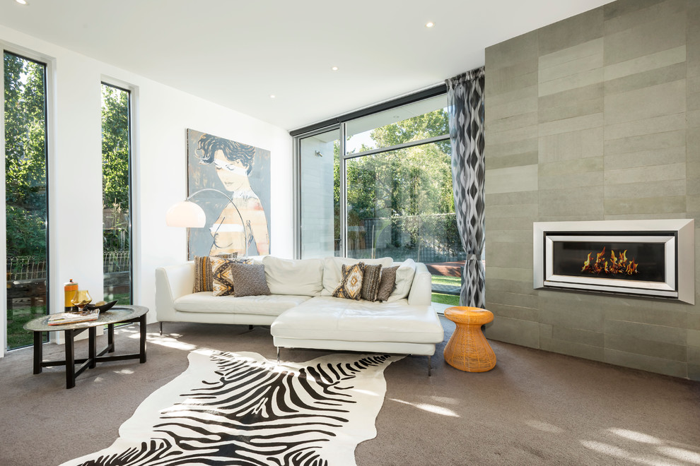 Contemporary formal living room in Melbourne with white walls, carpet, a ribbon fireplace and no tv.