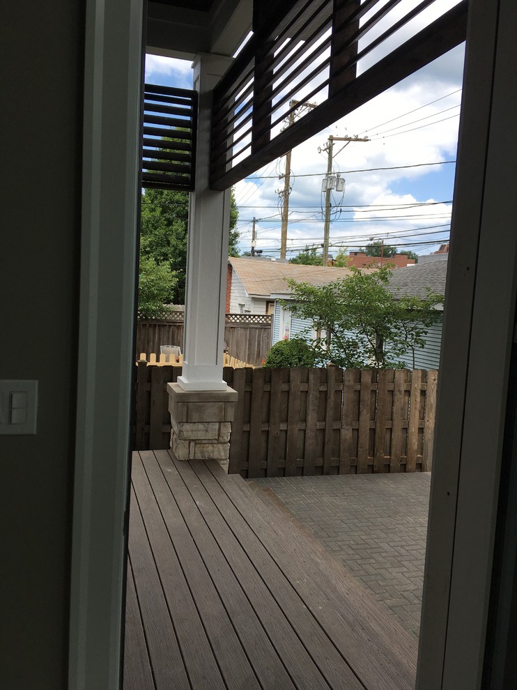 Inspiration for a large transitional backyard home design remodel in Chicago with a roof extension