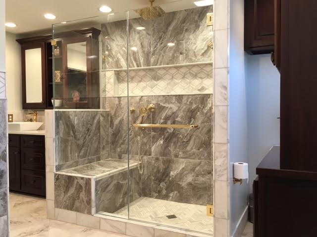 Master Bath w/ custom Mahogany cabinets, large porcelain tiles and marble tiles