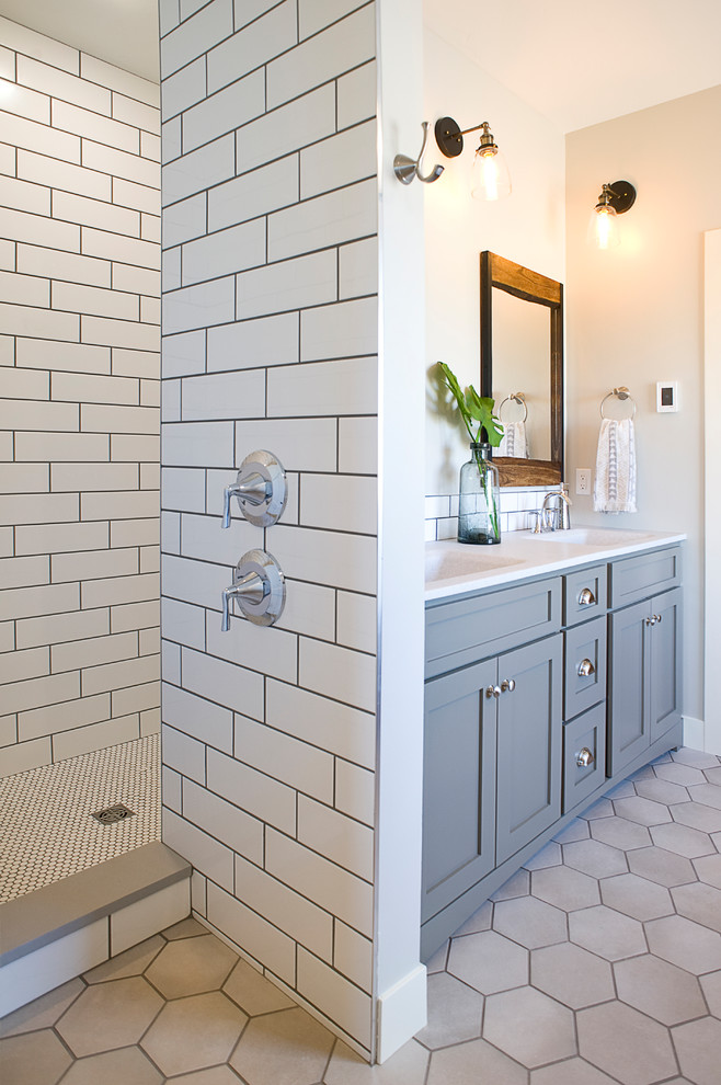 Photo of a large transitional master bathroom in Other with shaker cabinets, green cabinets, a drop-in tub, an open shower, a one-piece toilet, subway tile, grey walls, ceramic floors, an integrated sink, onyx benchtops, beige floor, an open shower and yellow benchtops.