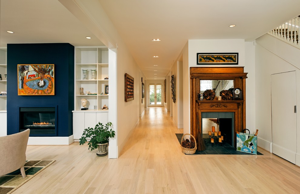Photo of a mid-sized transitional entry hall in DC Metro with white walls, light hardwood floors, a double front door, a glass front door and beige floor.