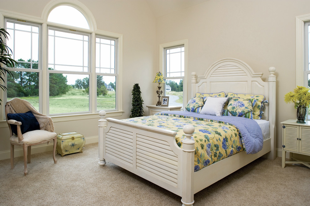This is an example of a large traditional master bedroom in Charlotte with white walls, carpet and no fireplace.