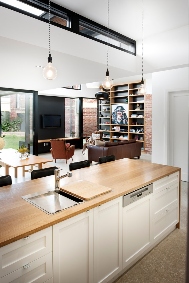 Photo of a small eclectic galley kitchen pantry in Adelaide with a drop-in sink, recessed-panel cabinets, medium wood cabinets, wood benchtops, green splashback, subway tile splashback, coloured appliances, concrete floors and with island.