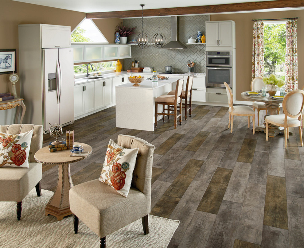 Inspiration for a mid-sized transitional l-shaped vinyl floor and gray floor open concept kitchen remodel in Atlanta with an undermount sink, shaker cabinets, white cabinets, quartzite countertops, gray backsplash, stainless steel appliances and an island
