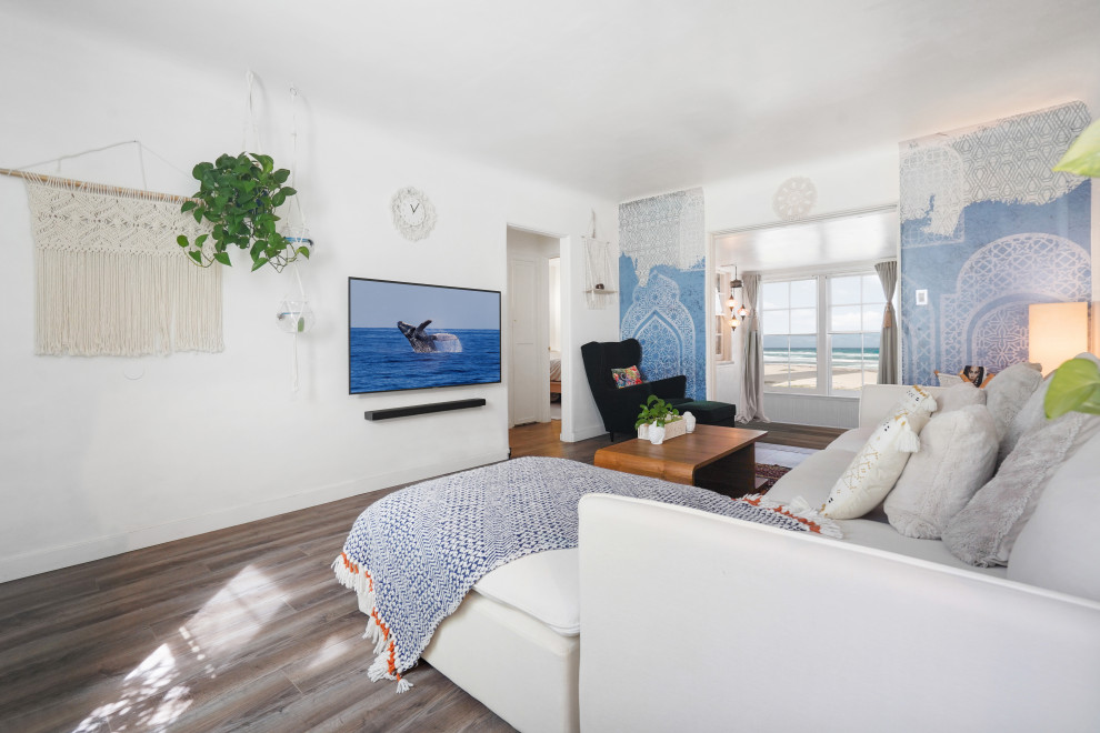 Idee per un soggiorno mediterraneo di medie dimensioni e aperto con pareti bianche, pavimento in legno massello medio, TV a parete e pavimento multicolore