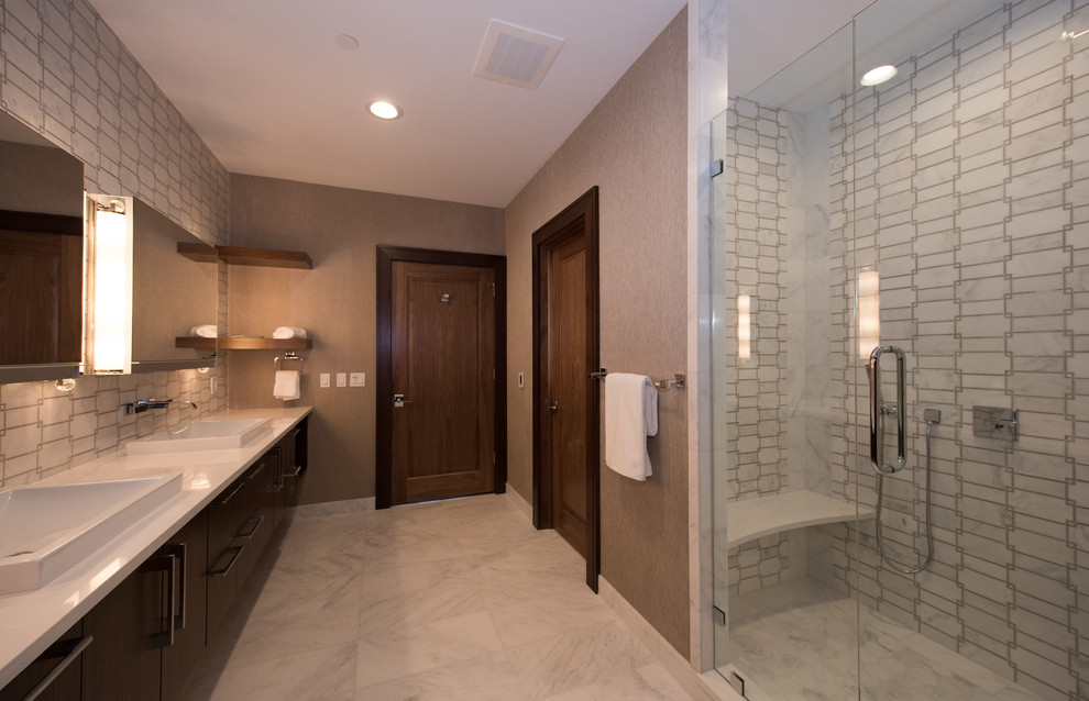 Inspiration for a midcentury master bathroom in Other with flat-panel cabinets, brown cabinets, an alcove shower, a one-piece toilet, white tile, marble, brown walls, marble floors, a drop-in sink, engineered quartz benchtops, white floor and a hinged shower door.