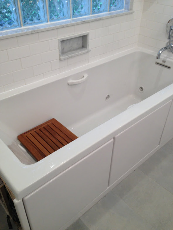 Inspiration for a mid-sized transitional 3/4 blue tile, gray tile, white tile and subway tile gray floor drop-in bathtub remodel in Chicago with white walls, furniture-like cabinets, white cabinets, an integrated sink and glass countertops